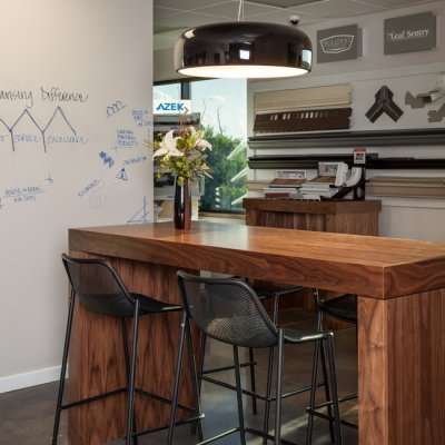 a wooden bar top with some metal stools