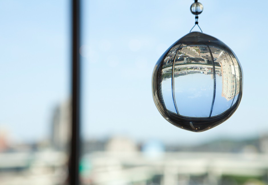 decorative glass sphere hanging in front of a city-view